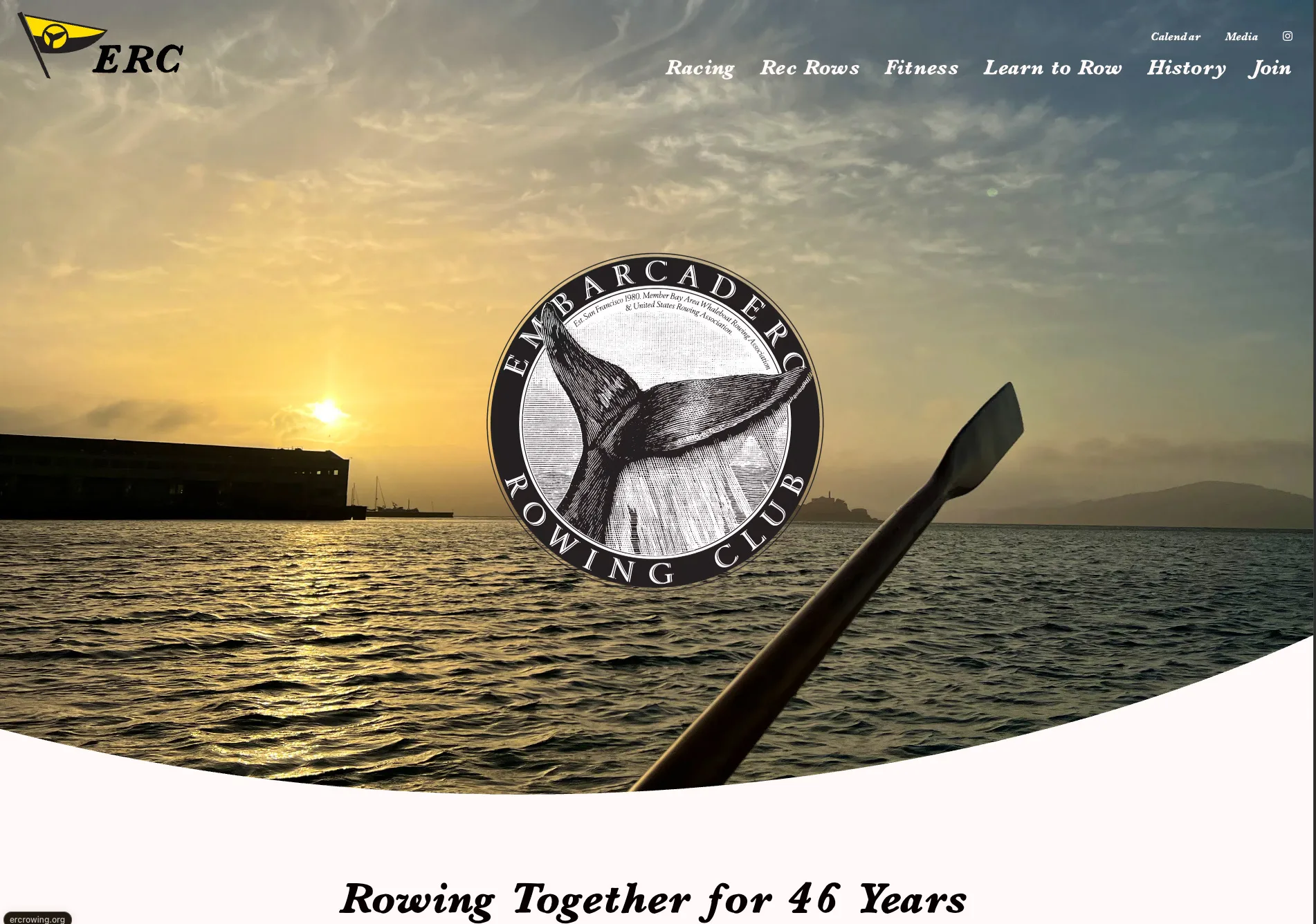 The Embarcadero Rowing Club homepage: a sunset over San Francisco Bay seen from a whaleboat, with an oar in the foreground and the club’s whale-tail seal at center